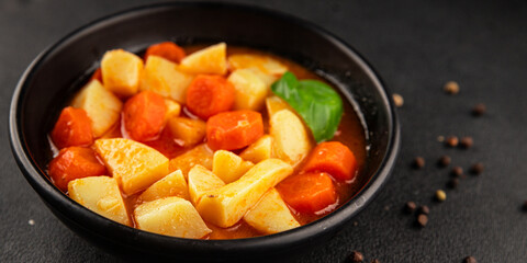 Stewed potatoes with carrots vegetarian side dish fresh delicious gourmet food background on the table rustic food top view copy space keto and paleo diet vegan food