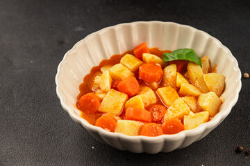 Stewed potatoes with carrots vegetarian side dish fresh delicious gourmet food background on the...