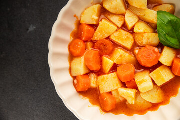 Stewed potatoes with carrots vegetarian side dish fresh delicious gourmet food background on the table rustic food top view copy space keto and paleo diet vegan food