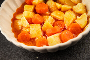 Stewed potatoes with carrots vegetarian side dish fresh delicious gourmet food background on the table rustic food top view copy space keto and paleo diet vegan food