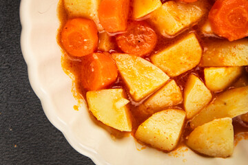Stewed potatoes with carrots vegetarian side dish fresh delicious gourmet food background on the table rustic food top view copy space keto and paleo diet vegan food