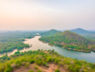 Blurred lake surrounded by green mountains