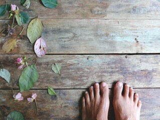 Barefoot on wooden floor surrounded by leaves and flowers indoor photography natural environment close-up view