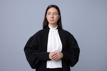 Portrait of judge in gown on gray background