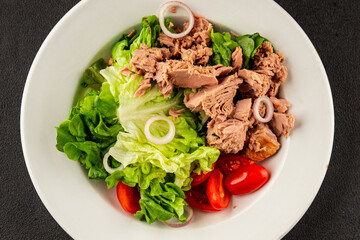 Tuna salad green leaf lettuce, canned tuna, tomato fresh delicious gourmet food background on the table rustic food top view copy space keto and paleo diet vegetarian food pescetarian diet