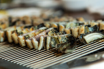 roasting eels on the charcoal grill