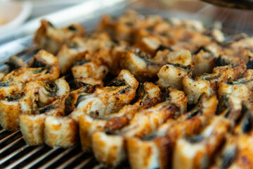 roasting eels on the charcoal grill
