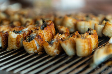 roasting eels on the charcoal grill