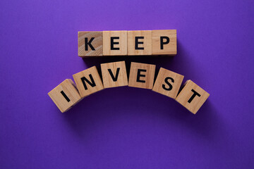 Keep investing in your future, financial advice with wooden cubes