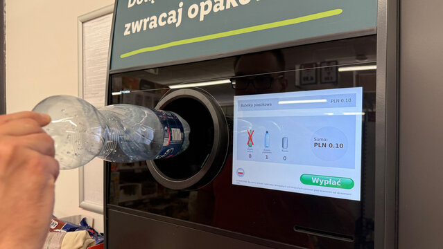 Warsaw, Poland - June 22, 2025: Recycling machine accepting plastic bottles with user interaction in store