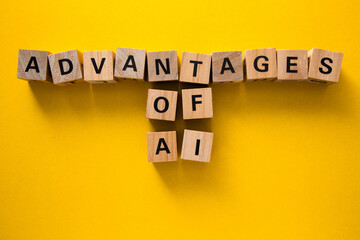 Advantages of artificial intelligence highlighted with wooden cubes on yellow background