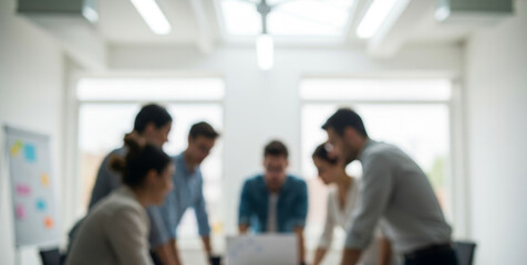 Group of people in a meeting room blurred focus on the table.
