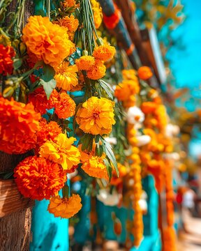 A vibrant display of marigold flowers in bright hues of orange and yellow, creating a lively and colorful atmosphere against a blue backdrop.