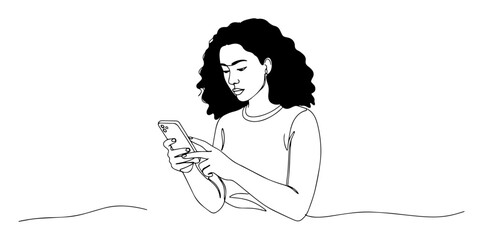 curly woman texting on mobile phone