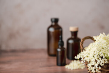 A wicker basket brimming with soft white flowers sits on a wooden surface next to a variety of...