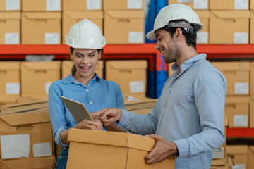 Warehouse worker working in warehouse storage. Foreman or worker work at factory site check up...
