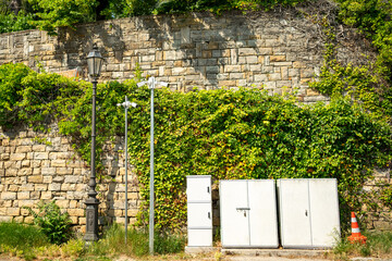 Industrial street infrastructure including electrical cabinets, street lamps, and surveillance...