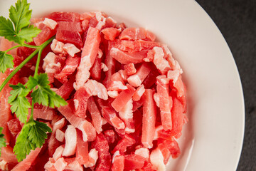 Bacon cubes smoked chopped meat small pieces fresh delicious gourmet food background on table rustic food top view copy space