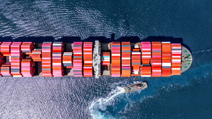 Aerial top view large cargo container ship at blue sea.