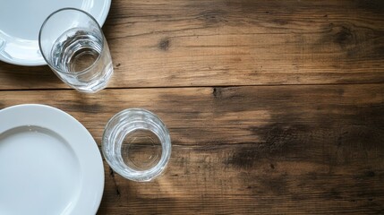 Neutral tones highlight the elegance of modern dining as white plates are arranged on earthy woven placemats in a top-down view setting.