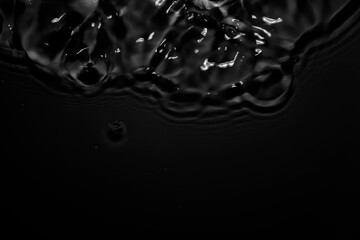 Image of black water surface with waves.