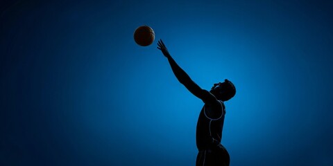 Silhouette of a male athlete mid-dunk with dynamic energy and focus, emphasizing the intensity of competition on the blue-lit gymnasium floor.