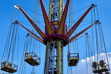 Empty flying swings in fairground close-up