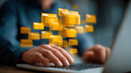 A man types on a laptop keyboard as digital folders float above the computer, representing file management, organization, and accessing important documents quickly.