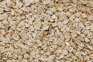 Oats spread across a surface highlighting their texture and natural color variations
