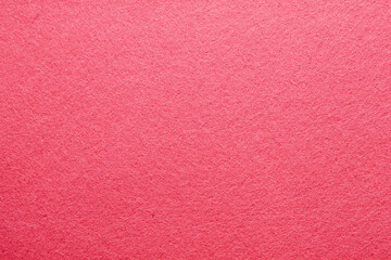 Textured pink surface creates a vibrant backdrop for artistic projects or crafts