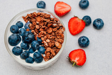 Healthy breakfast bowl with yogurt granola strawberries and blueberries for a nutritious start