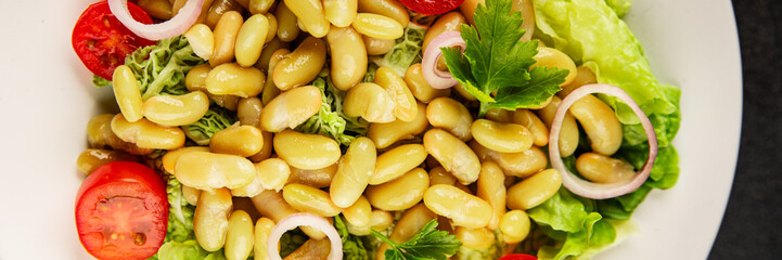 Bean salad green leaf lettuce, tomato, onion vegetables dish fresh delicious gourmet food background on the table rustic food top view copy space keto and paleo diet vegan and vegetarian food