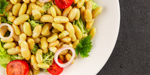 Bean salad green leaf lettuce, tomato, onion vegetables dish fresh delicious gourmet food background on the table rustic food top view copy space keto and paleo diet vegan and vegetarian food