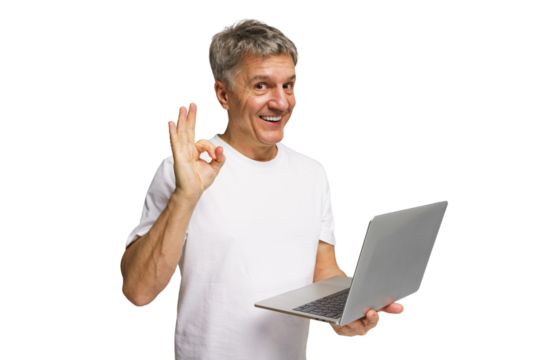 Smiling man in casual attire shows positive gesture while holding a laptop in a bright, transparent background