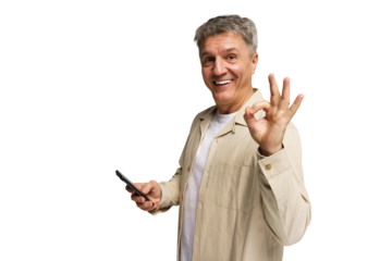 Smiling man showing the okay gesture while holding a smartphone in a bright, without a background