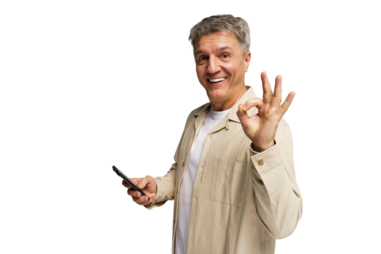 Smiling man showing the okay gesture while holding a smartphone in a bright, without a background - Powered by Adobe
