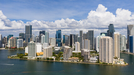 Fototapeta premium Drone view of Brickell skyscrapers. Brickell cityscape of downtown Miami. Panoramic Miami Brickell skyline above the coastline. Brickell Key aerial view in Miami. Landscape of Miami.
