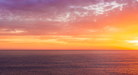 beautiful sunrise or sunset seascape with amazing calm sea water with waves and colorful amazing cloudy morning sky on background