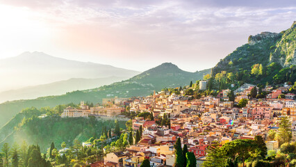 panoramic view of beautiful sunset in old european town with vintage buildings and great mountains...