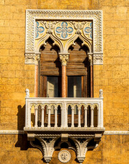 old vintage window of a golden vintage palace in Italy with antique decorations of medieval...