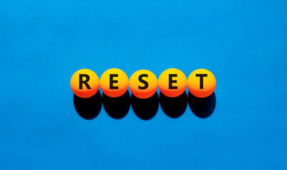 Reset symbol. Concept word Reset on beautiful yellow tennis ping pong balls. Beautiful wooden table...