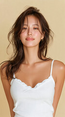 Fototapeta premium Natural Korean Woman with Dewy Skin and Relaxed Expression in Cream Background