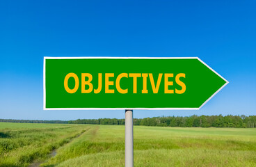 Objectives symbol. Concept word Objectives on beautiful green road sign. Beautiful blue sky green grass and forest peaceful nature background. Business objectives concept. Copy space.