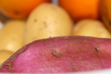 A colorful selection of vegetables and fruits with selective focus. Sweet potato with selective...
