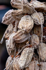 Dried persimmon fruits are sold at the market. Fruits