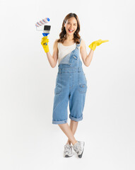 Appealing Asian woman holds paintbrushes on white background.