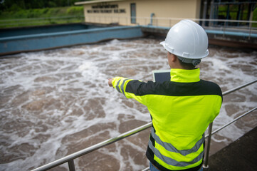 A wastewater treatment engineer is checking the operation of a water treatment system