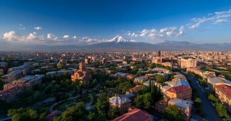 A photo of city with red-roofed houses and the large, white Mount Ararat in the background, with some trees, 