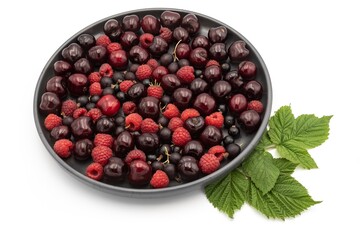 Cherry, raspberry and currant composition on a black plate on a white background - close-up of a berry composition