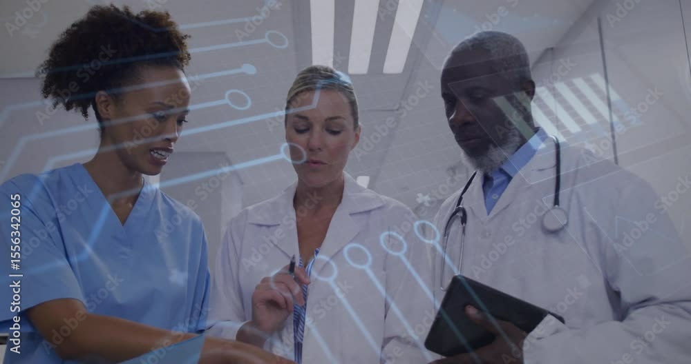 Poster medical team pointing at charts using tablet as transparent overlay appearing fading for analysis